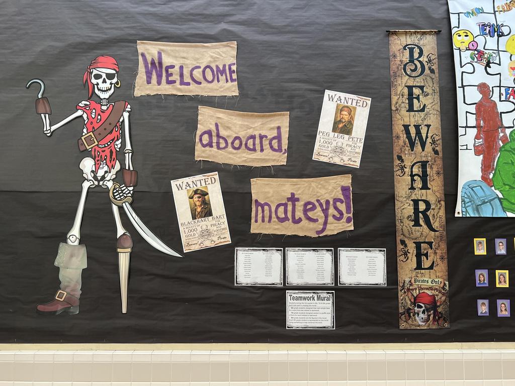 A "Welcome Aboard Mateys!" bulletin board in the school hallway.