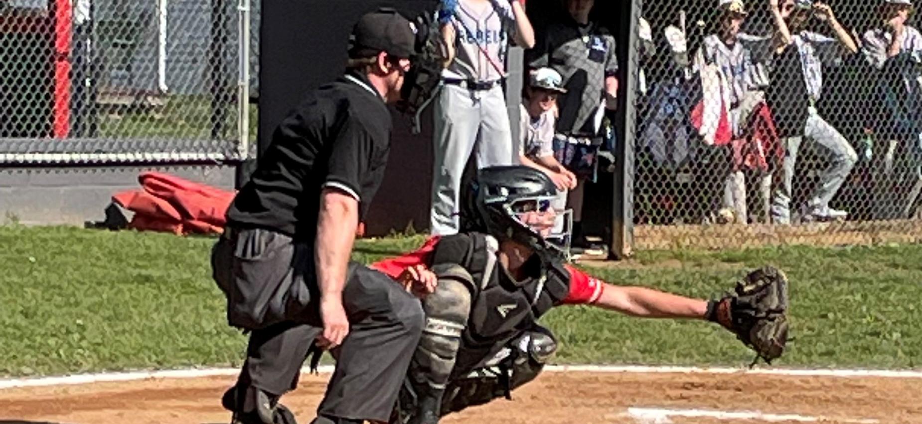 A baseball catcher waits for the pitch.
