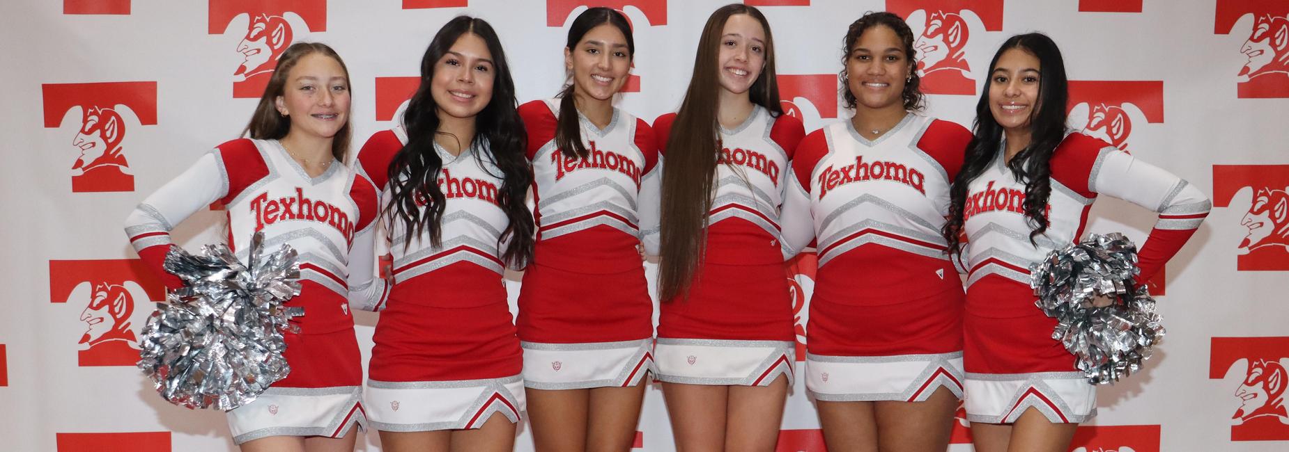 Group of five cheerleaders in red and white uniforms posing together.