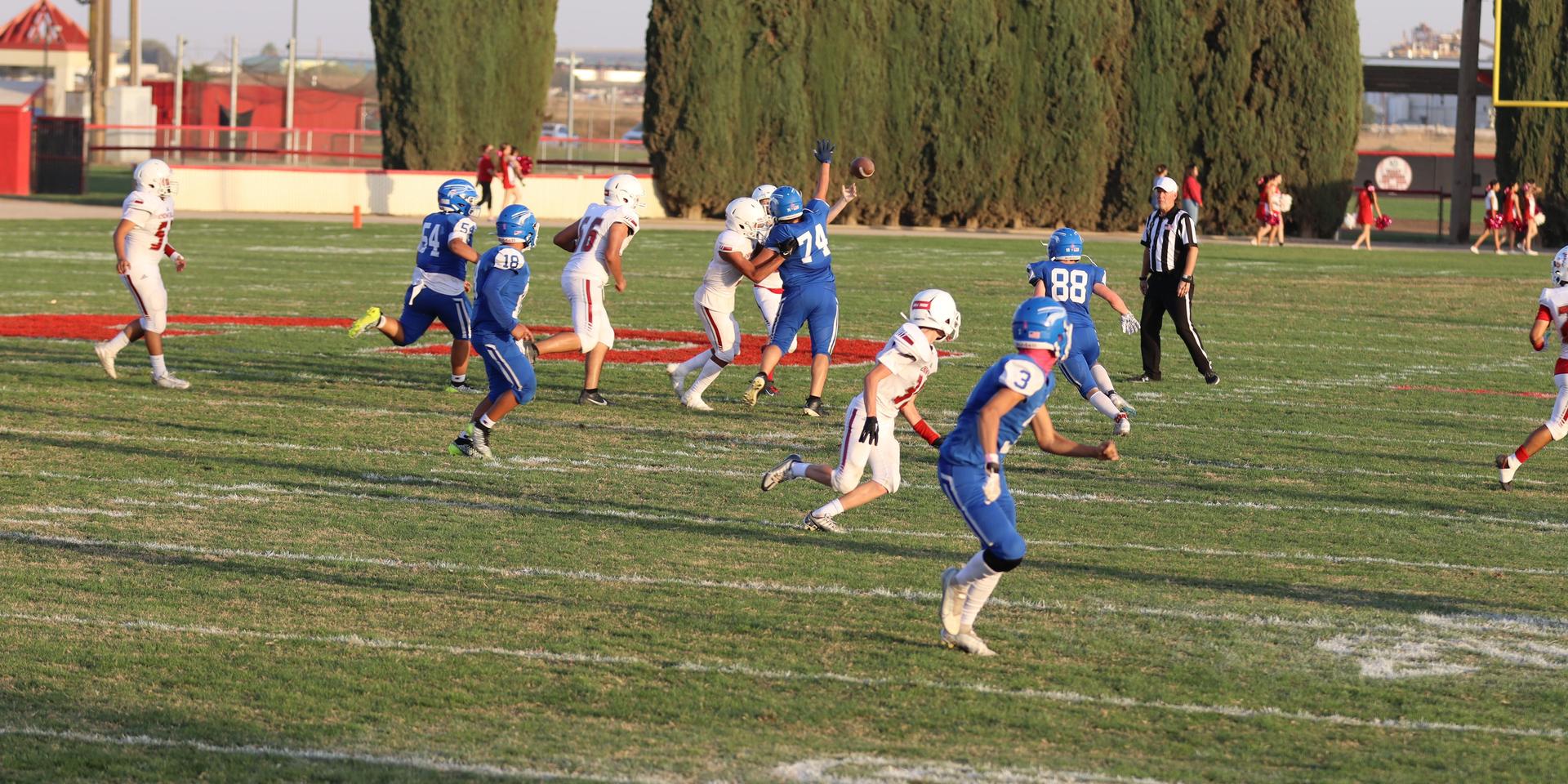Junior Varsity football players in action against Caruthers