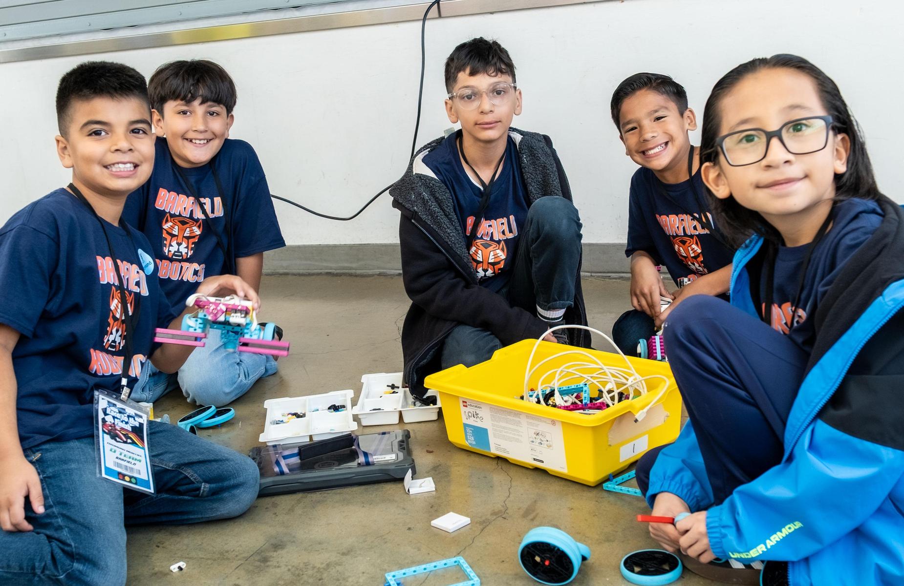 5 students smile at camera