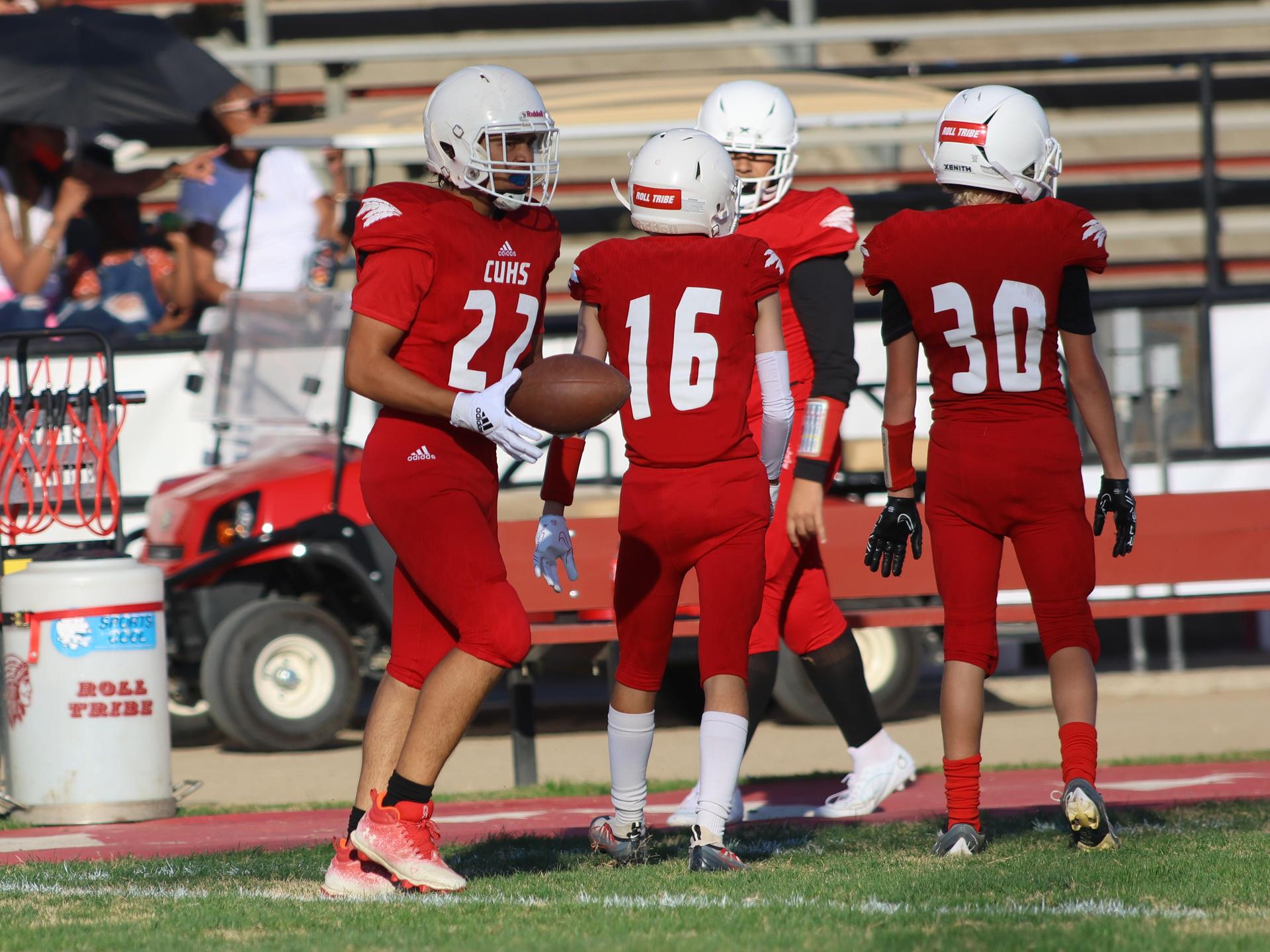junior varsity football players in action against Fowler