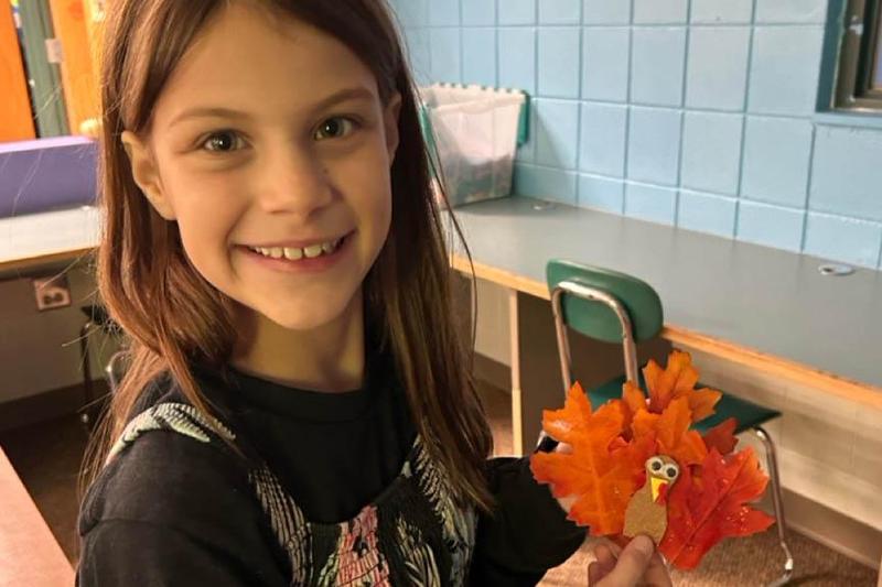 5th-grader Minda Raithel holds her turkey craft