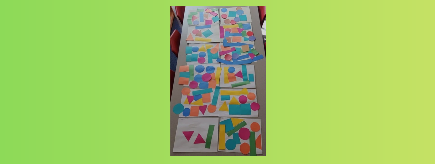 Colorful geometric shapes arranged on a table with a green background.