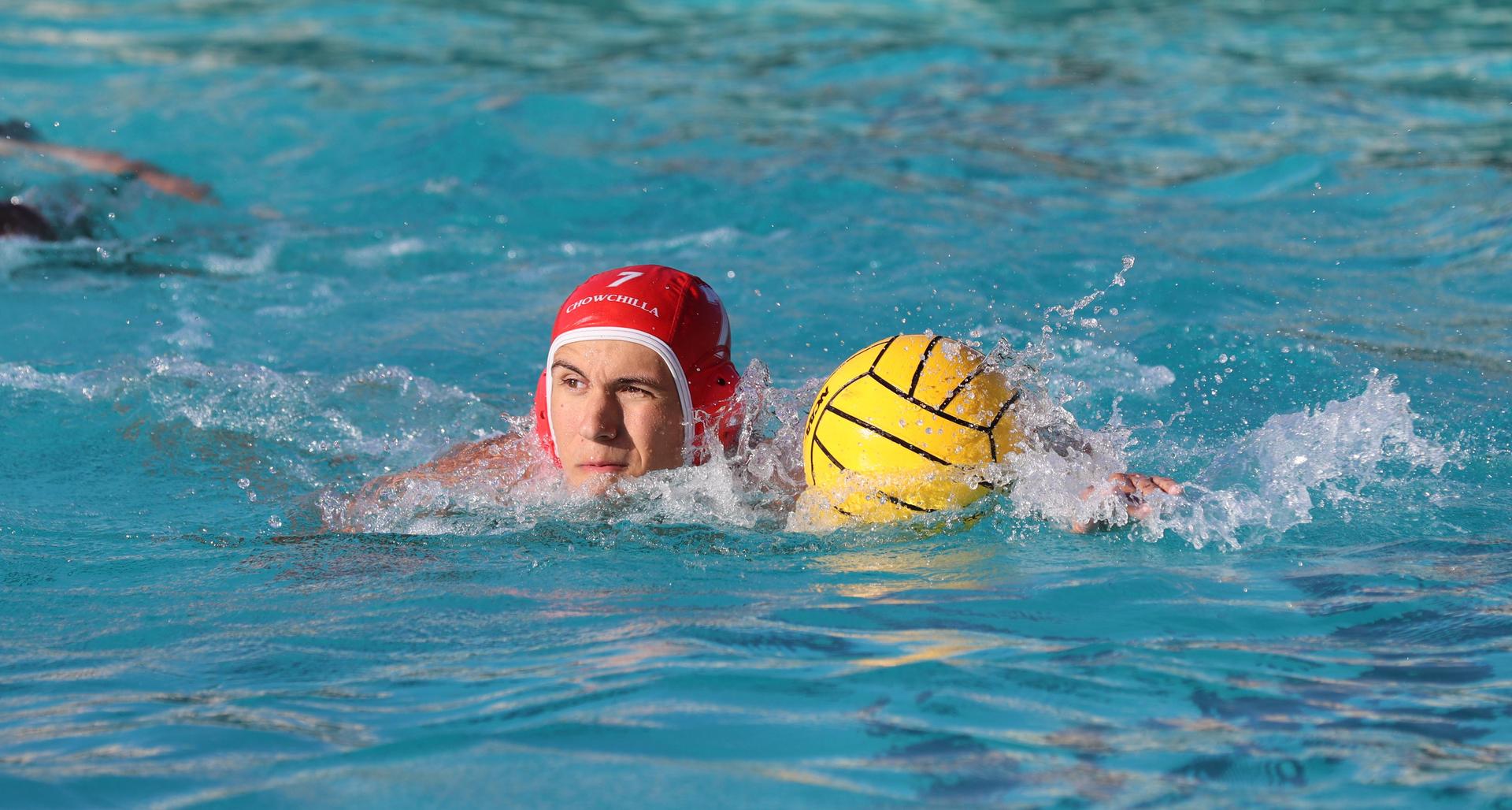 boys water polo players in action against hoover