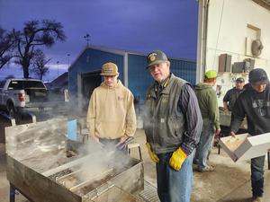 Community members cooking Rocky Mountain Oysters.