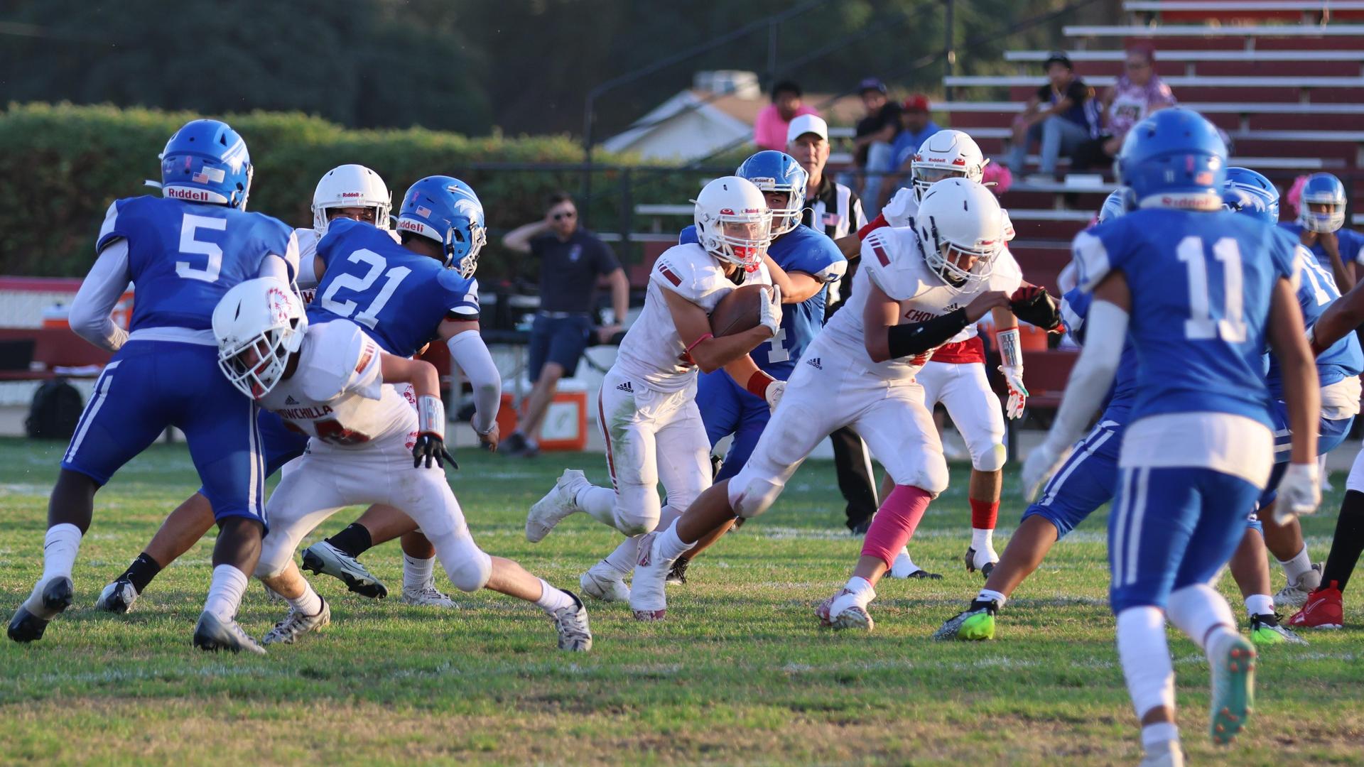 Junior Varsity football players in action against Caruthers