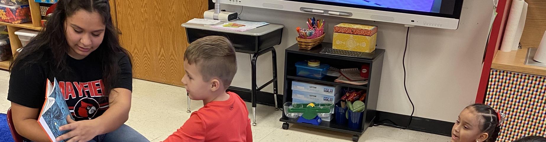 MES students loved having MHS students in their class reading books.