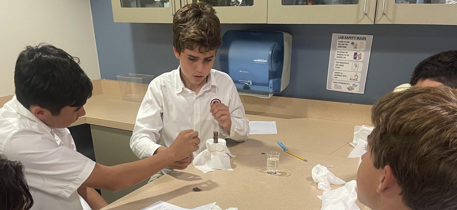 students using pennies for experiment