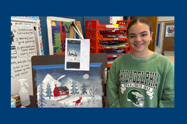 Middle School Student standing next to her artwork.