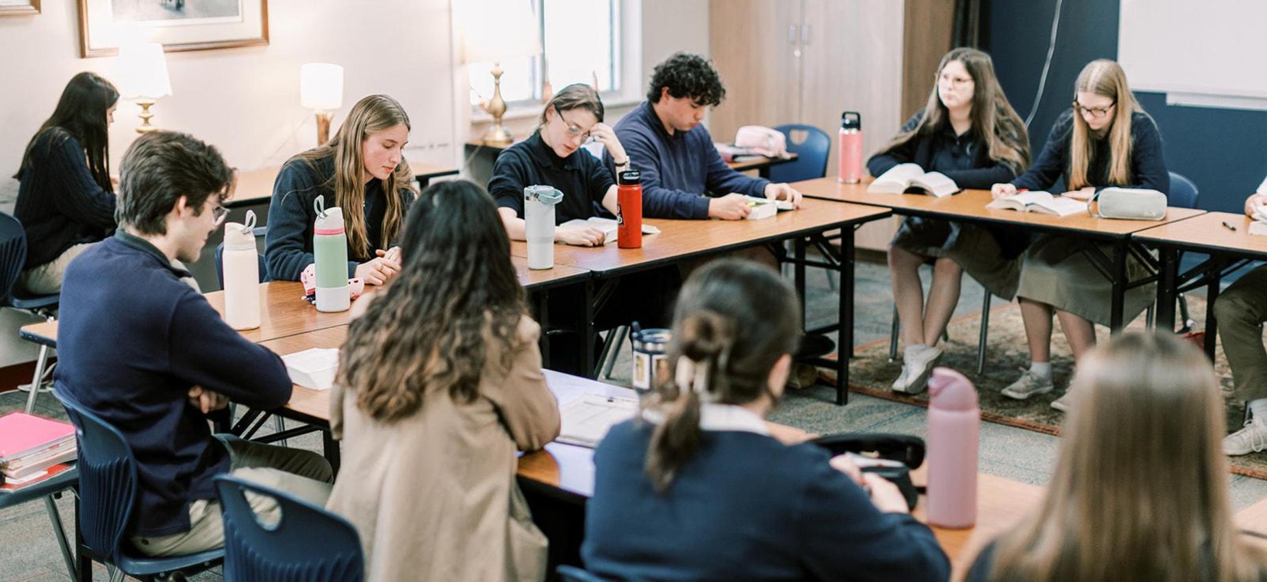 High school students discuss a reading around a seminar table