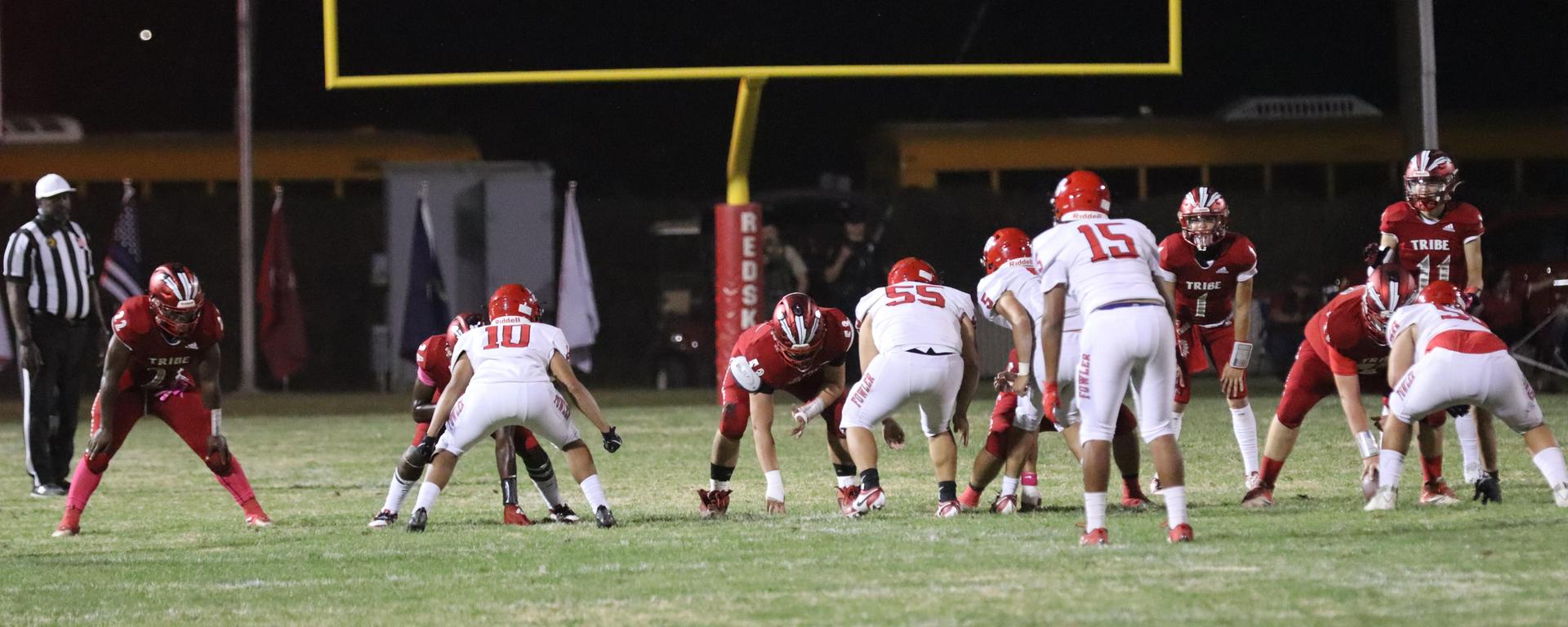 varsity boys playing football against Fowler