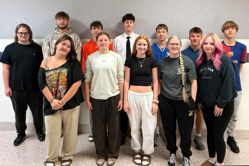 Students smile as they pose for a group picture.