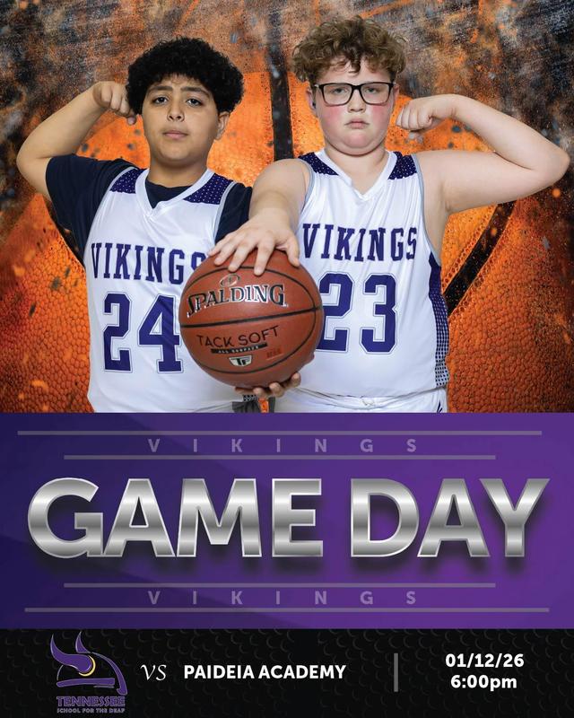 Two young basketball players posing with a ball, wearing Viking jerseys, against a game day backdrop.