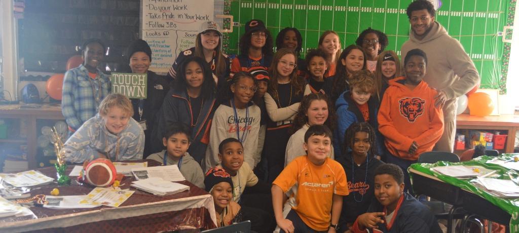 football player poses with class for photo