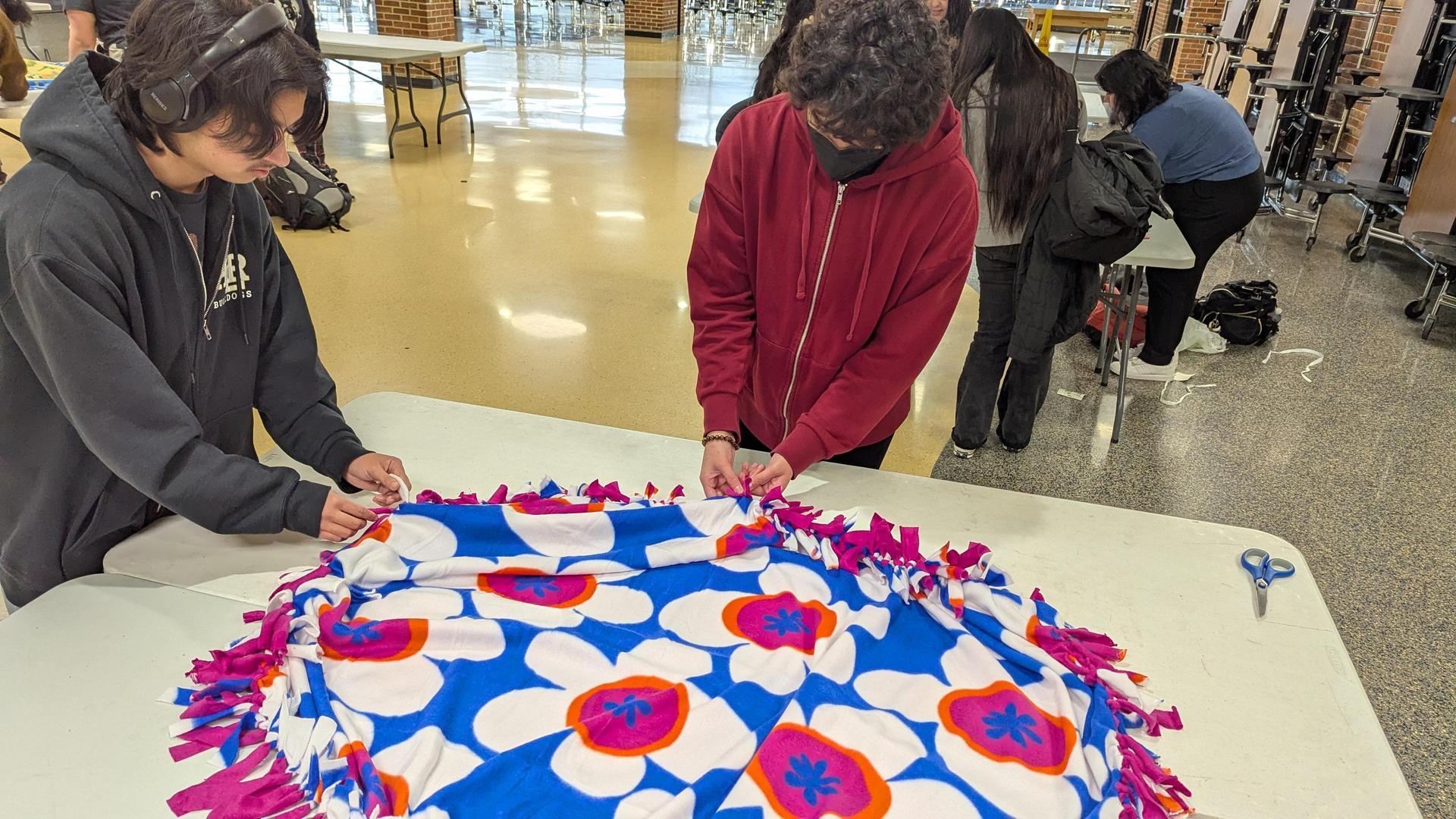 Photo of teenagers making a blanket