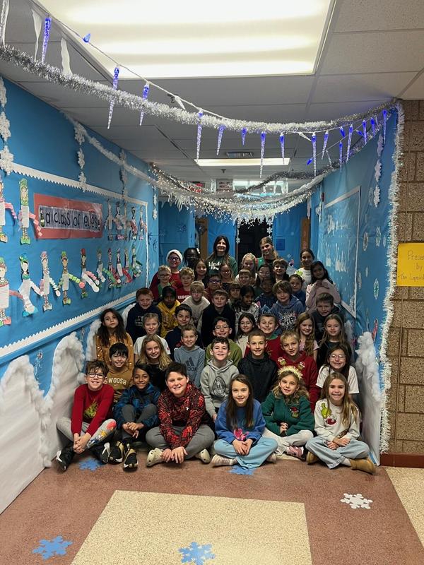 a group of students sitting in a school hallway
