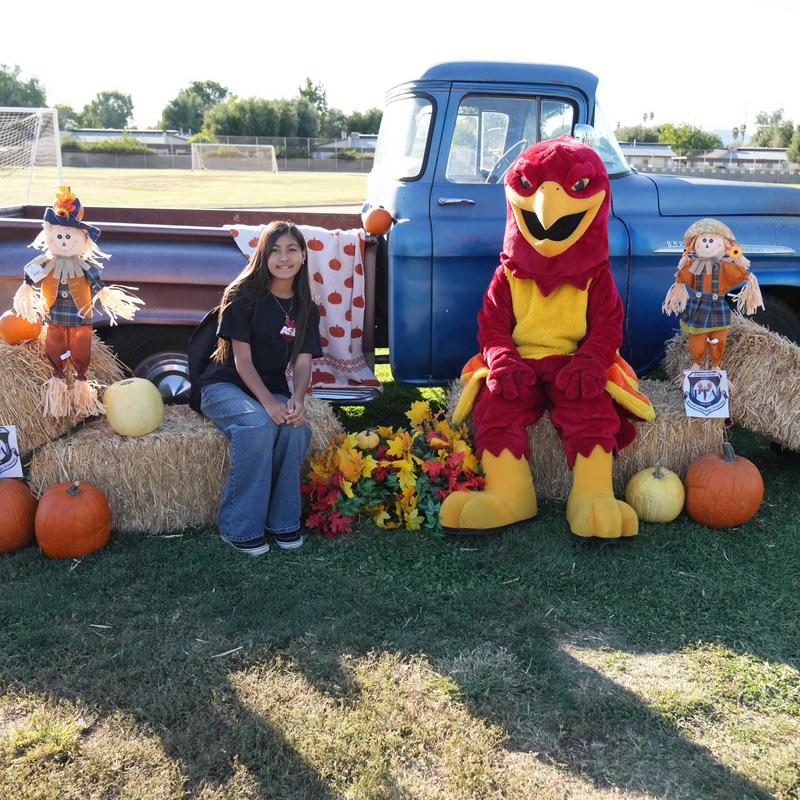 student and mascot in at Hyatt's Harvest Festival