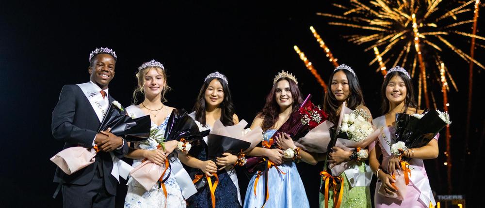 students on the football field with fireworks