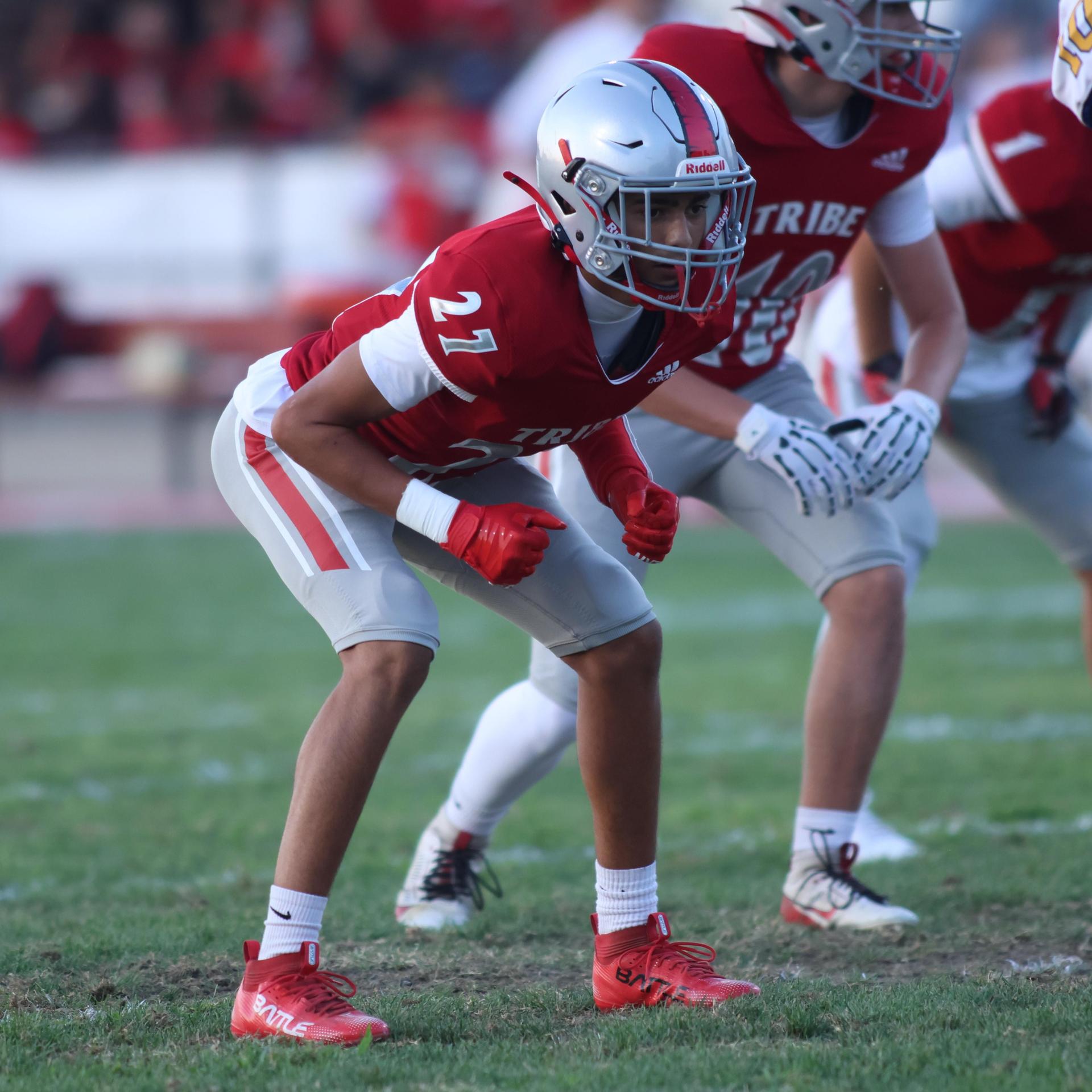 Varsity football players in action against Parlier 130