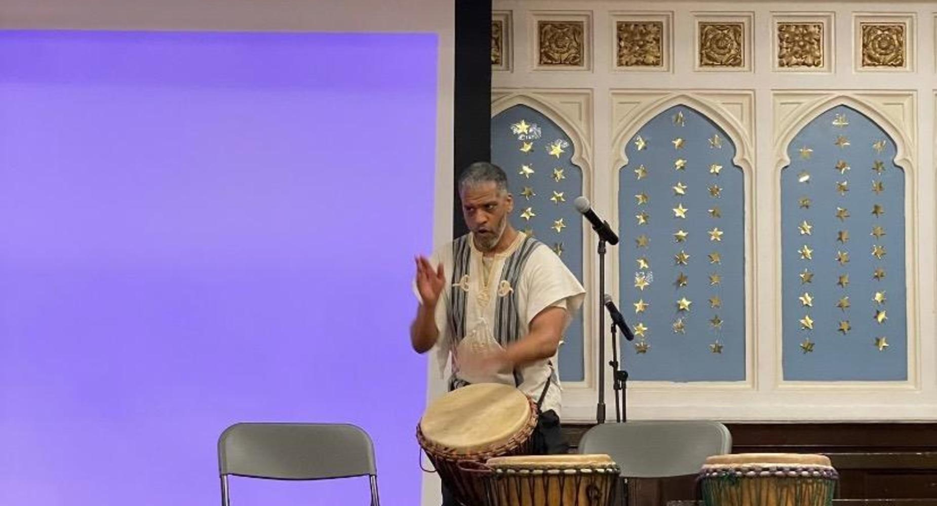African male drummer with drums on the stage