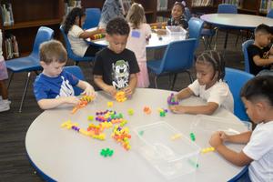 Students play in the library on the first day of school 2025-2026