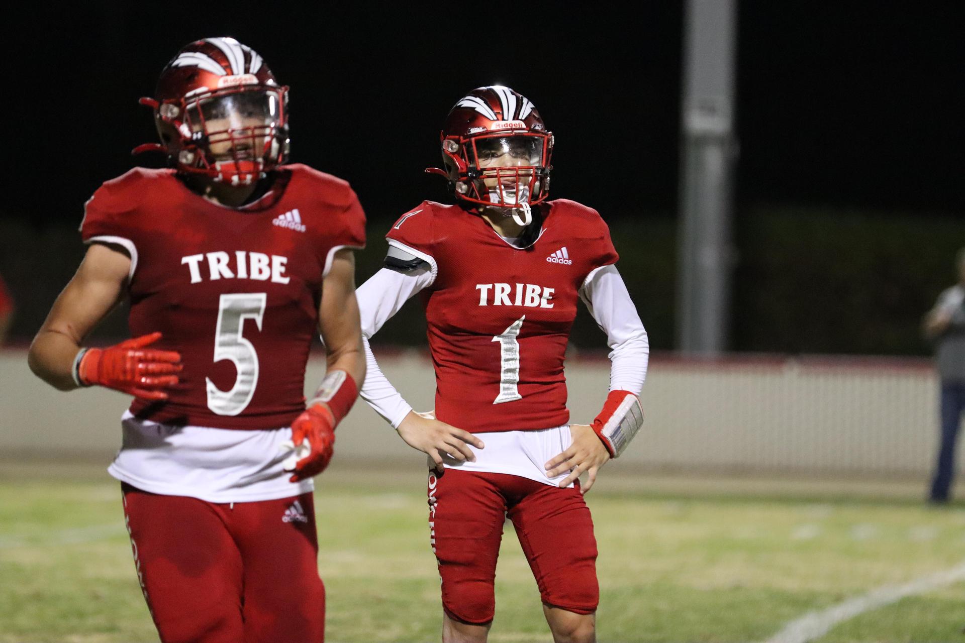 varsity football players in action against Riverdale