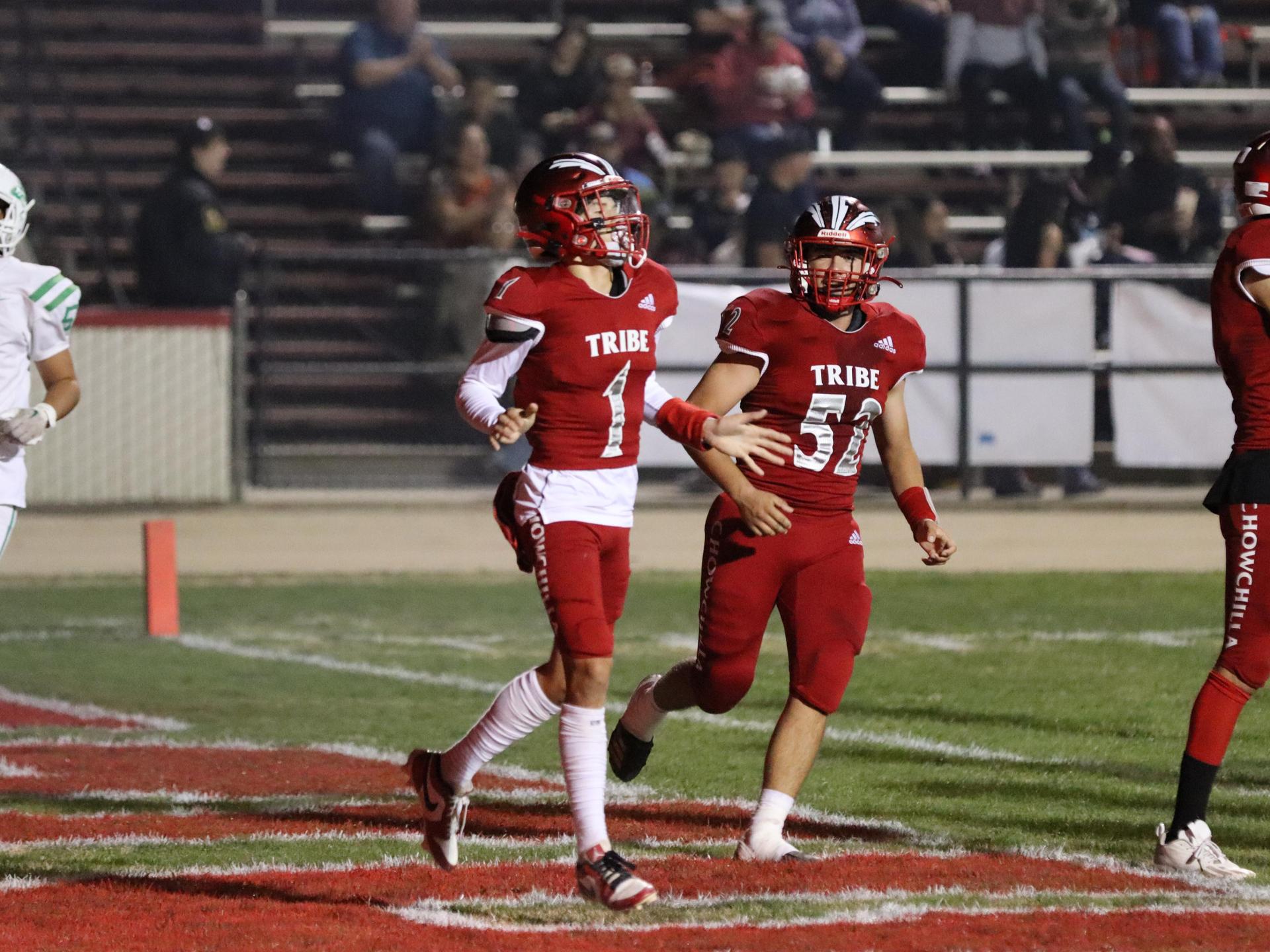 varsity football players in action against Riverdale