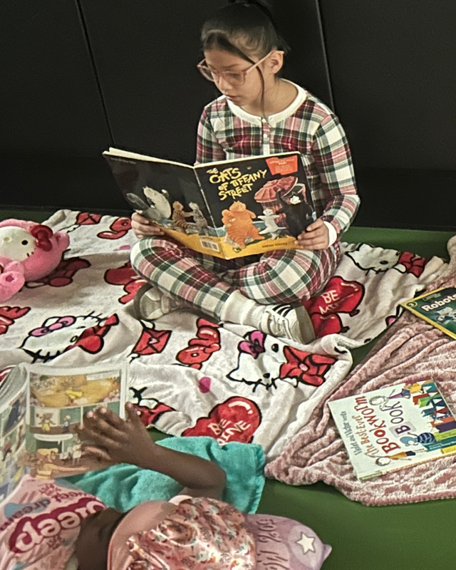 Student in PJs reading