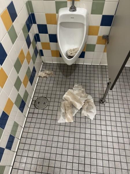 paper towels left to clog the urinal