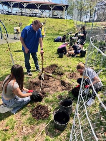 Mr. Hupp helps students with tree planting