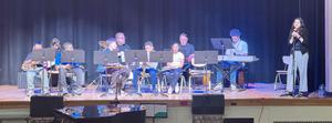 Students playing music on stage.