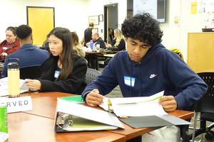 Student members of the advisory committee review provided material.