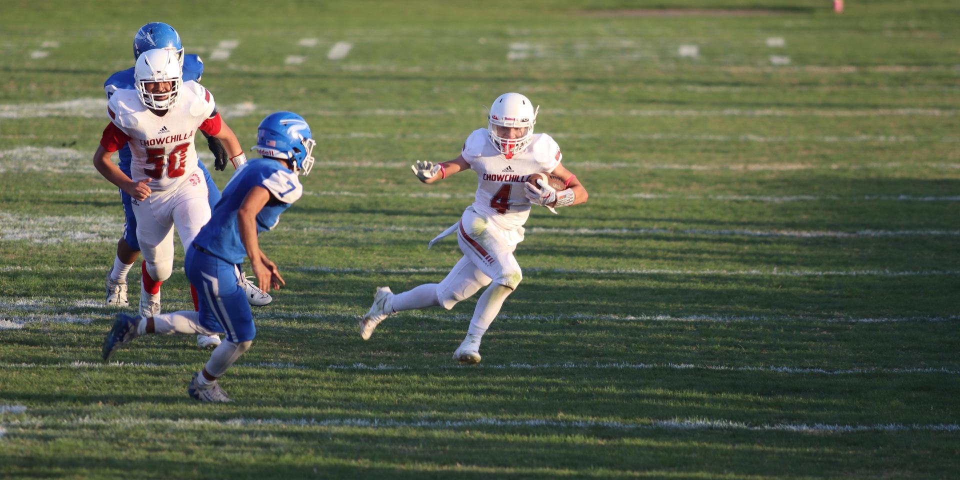 Junior Varsity football players in action against Caruthers