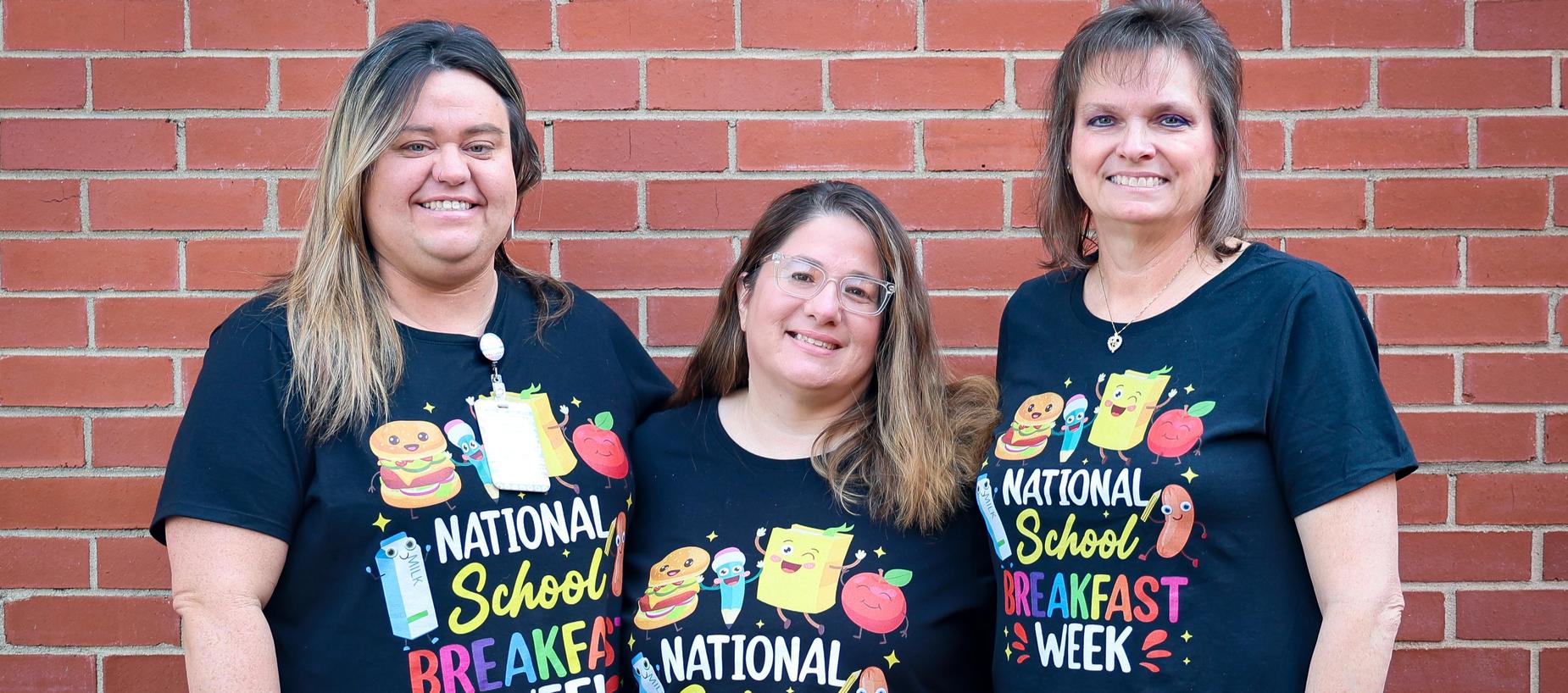 Three individuals in matching shirts for National School Breakfast Week.