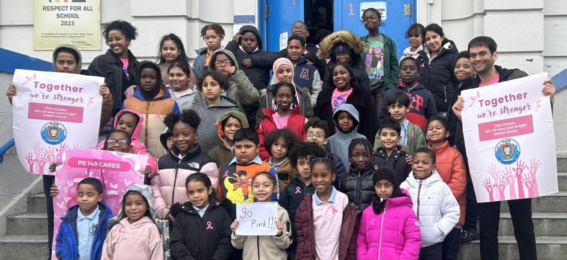 class photo in front of school for breast cancer awareness