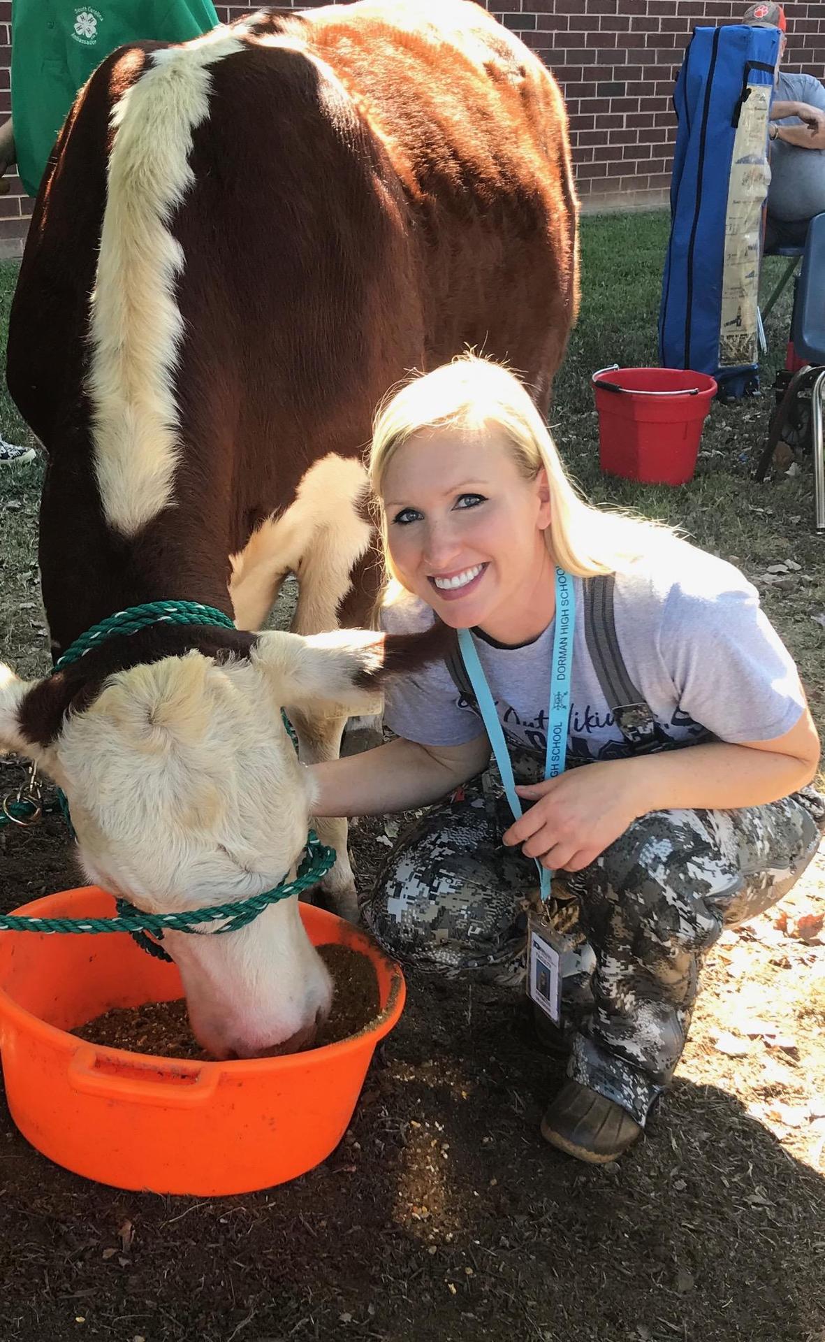 female teacher with a cow