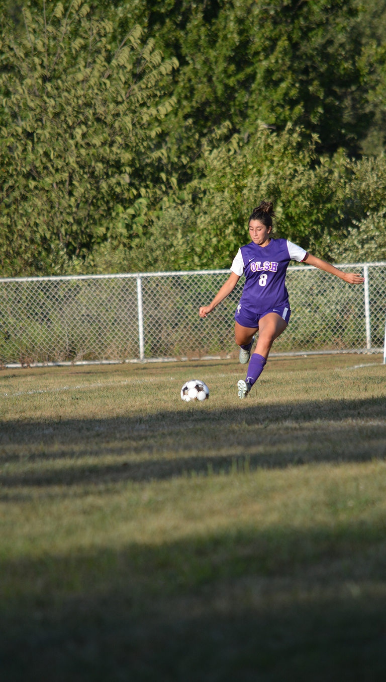 OLSH girls soccer player moves the ball down the field