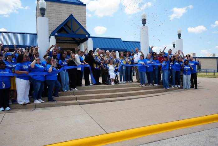 Confetti shot in the air as a ribbon is cut