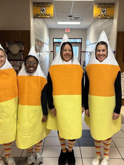 Teachers dressed as candy corn for Halloween