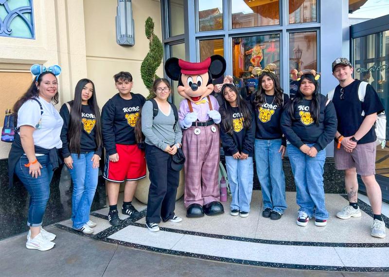 Middle school students pose for a group photo at Disneyland