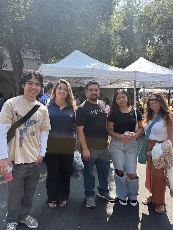 five persons smile at fair