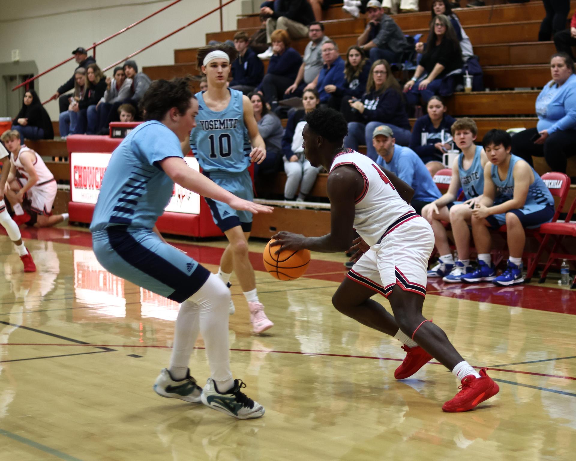Varsity boys playing basketball against yosemite