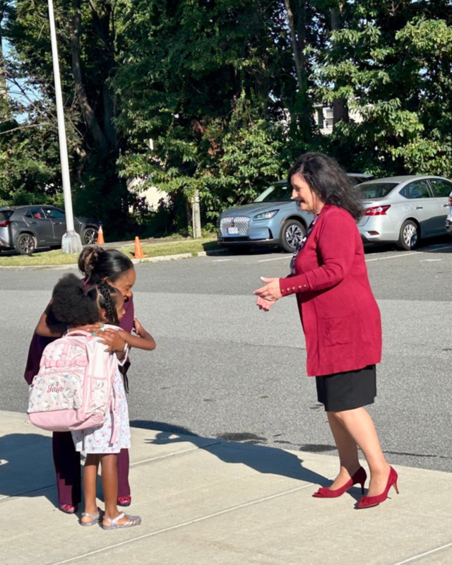 Dr. Chisolm greet student at LFJ with Ms. Simone