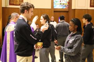 Brady distributes Holy Communion for the first time.