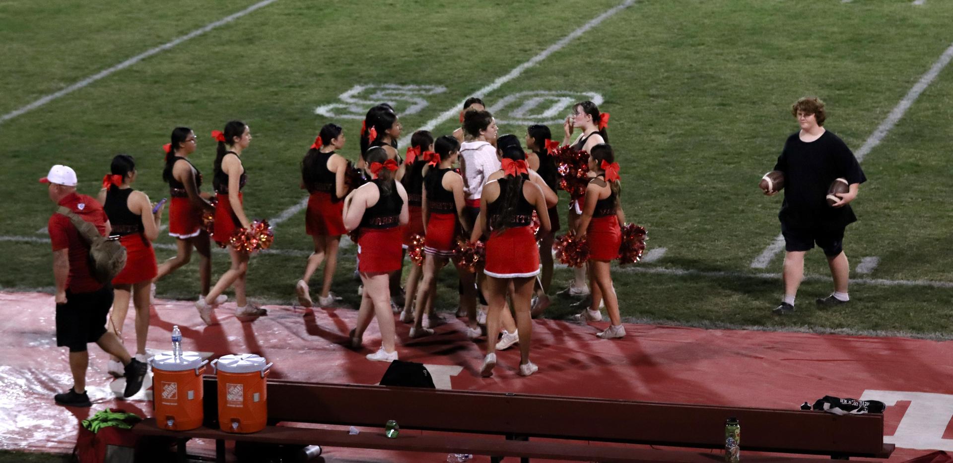Varsity girls cheering at the Parlier football game