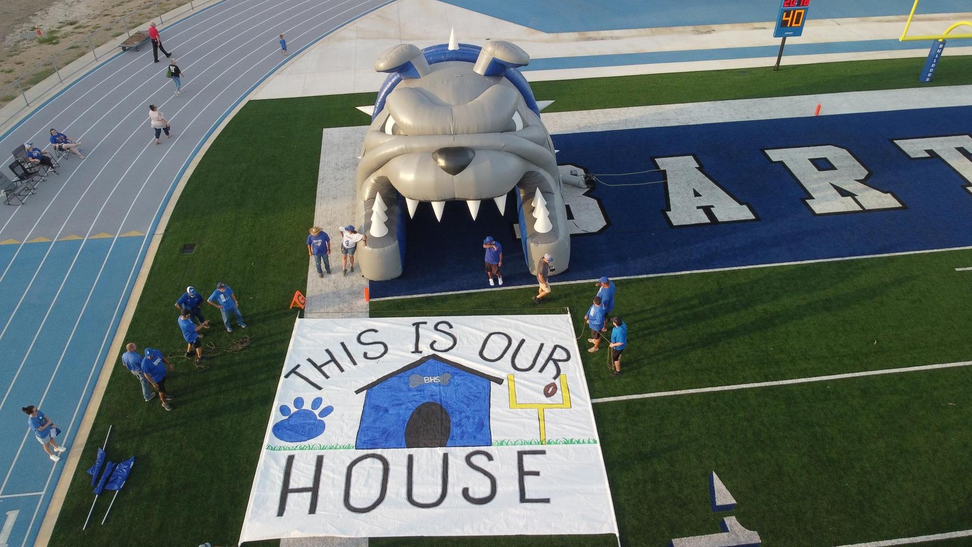 Bulldog mascot entrance with a large banner reading 'THIS IS OUR HOUSE'.