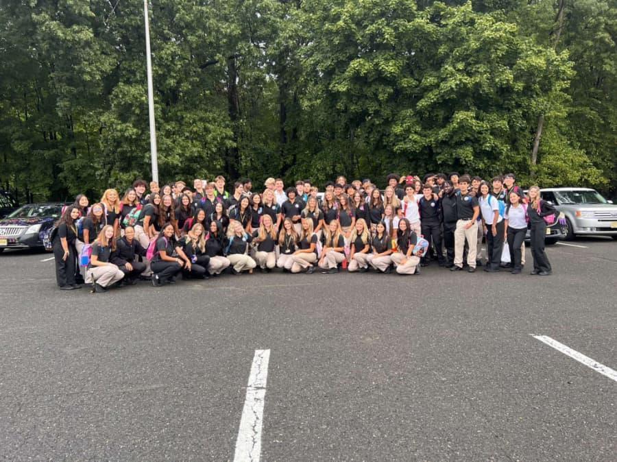 Large Group of Senior High School Students Gathered for Photo in Parking Lot