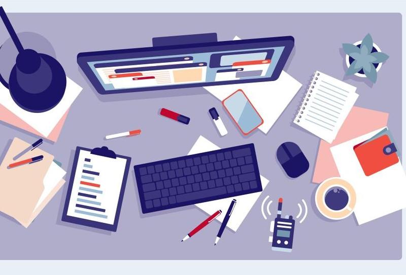 a desk with a computer screen, notebooks, pens