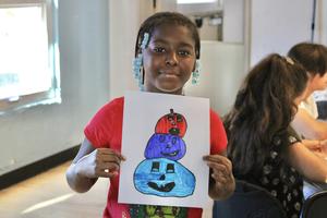 Student holding artwork